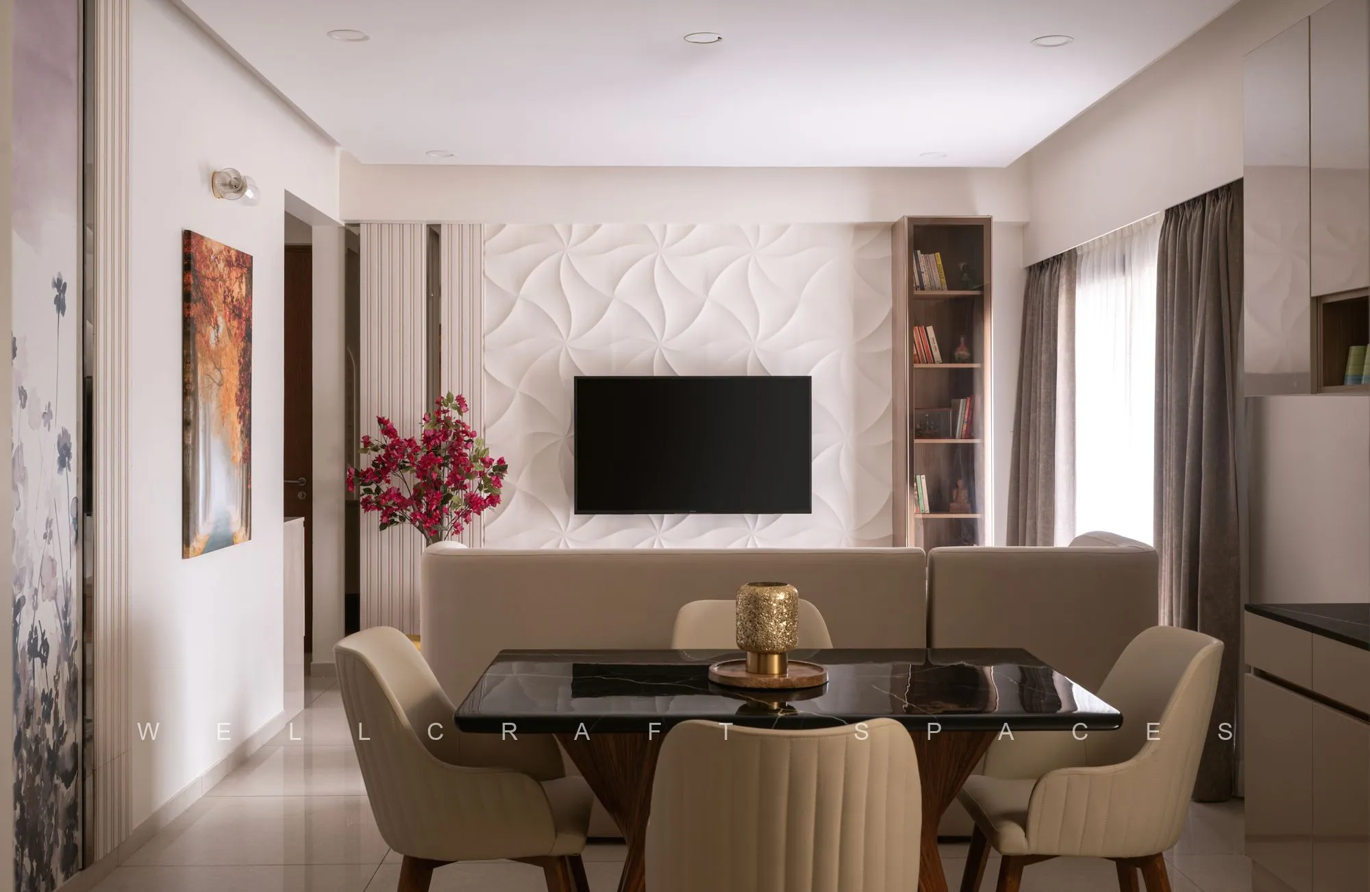 Open-plan living and dining in warm ivory, with a sculpted white 3D feature wall behind the television, a glass-top dining table and fluted cream chairs.