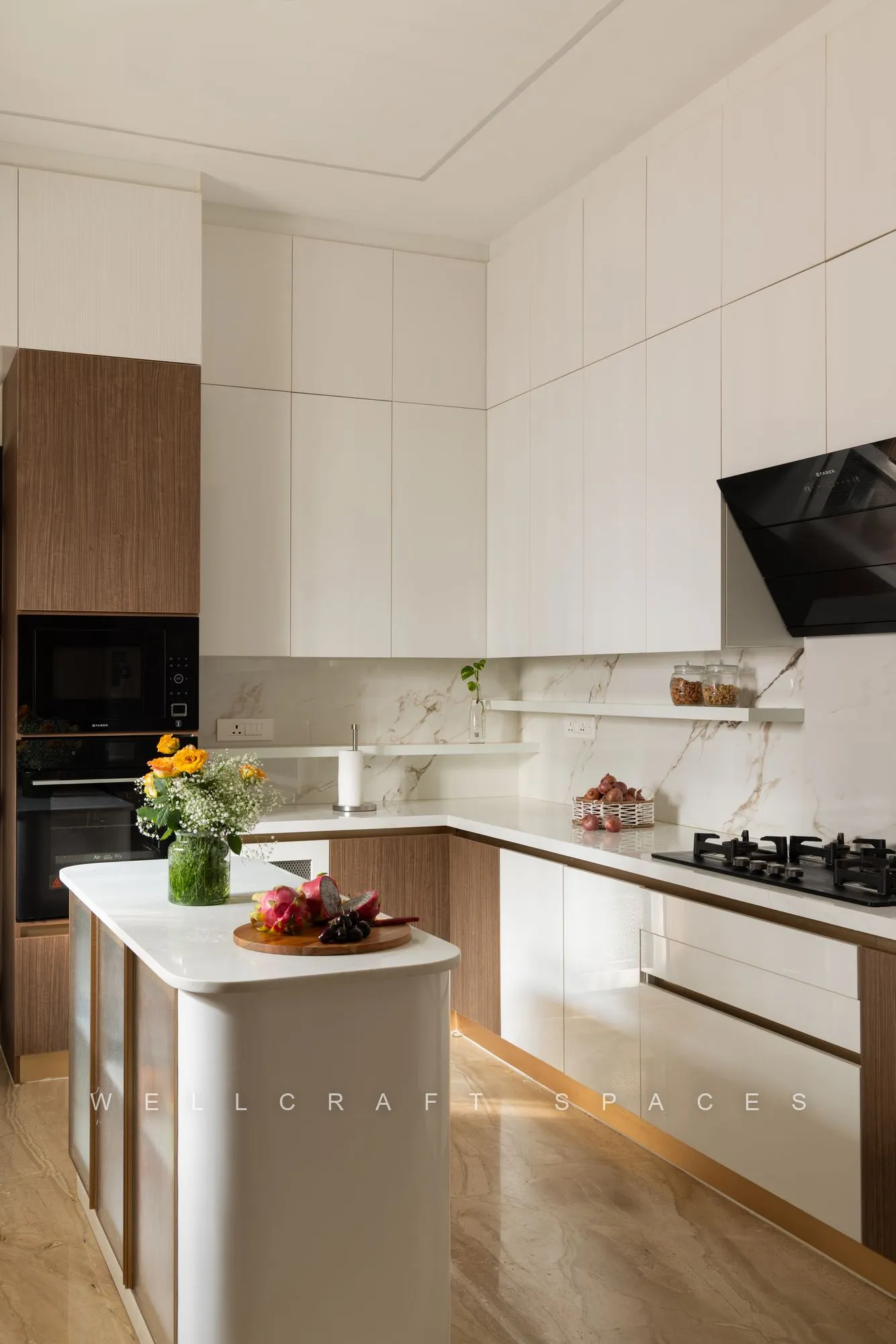 Matte white kitchen with a waterfall-edge island, marble splashback and a built-in oven column.